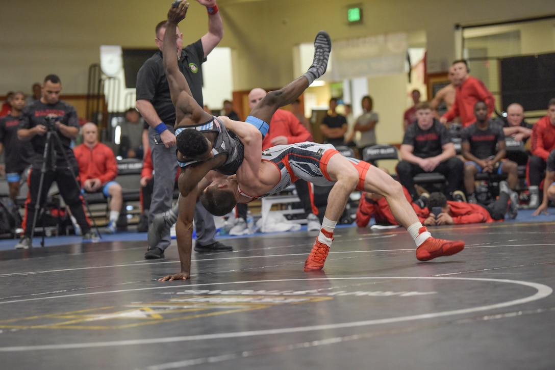 Hayden Tuma launches Xavier Johnson at 63 kg in the Army vs. Marines battle.  The 2019 Armed Forces Wrestling Championship held at the Soto Physical Fitness Center at Fort Bliss, Texas from 23-24 February featuring the top wrestlers in the United States from the Army, Marine Corps, Navy, Air Force and Coast Guard.  (U.S. Navy photo by Petty Officer 2nd Class J.E. Veal)