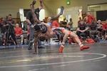 Hayden Tuma launches Xavier Johnson at 63 kg in the Army vs. Marines battle.  The 2019 Armed Forces Wrestling Championship held at the Soto Physical Fitness Center at Fort Bliss, Texas from 23-24 February featuring the top wrestlers in the United States from the Army, Marine Corps, Navy, Air Force and Coast Guard.  (U.S. Navy photo by Petty Officer 2nd Class J.E. Veal)