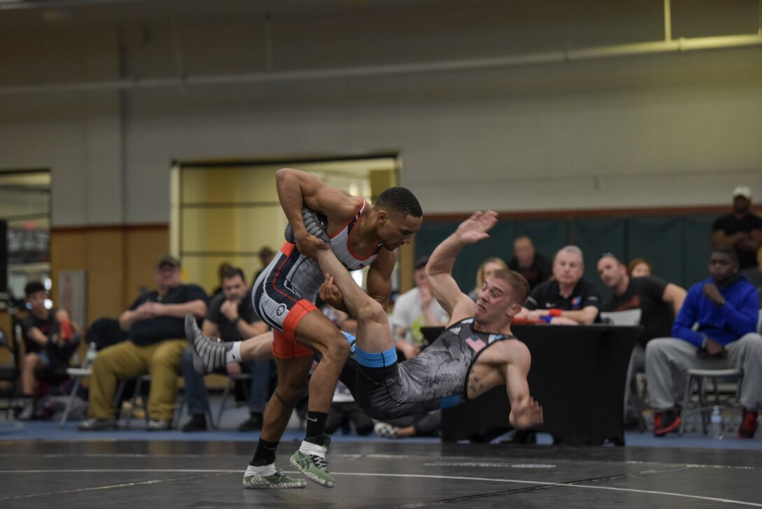 SPC Leslie Fuenffinger of the Army scores a powerful takedown of 1stLt Colton Rasche of Marines at 60 kg.  2019 Armed Forces Wrestling Championship held at the Soto Physical Fitness Center at Fort Bliss, Texas from 23-24 February featuring the top wrestlers in the United States from the Army, Marine Corps, Navy, Air Force and Coast Guard.  (U.S. Navy photo by Petty Officer 2nd Class J.E. Veal)