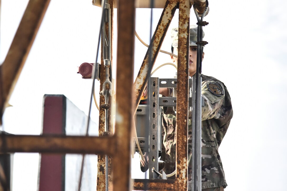Senior Airman Angelica Gutierrez, 380th Expeditionary Civil Engineer Squadron electrical systems journeyman, identifies wires in a junction box at Al Dhafra Air Base, United Arab Emirates, Feb. 18, 2019. Electrical systems specialists install, maintain, and repair energized and de-energized electrical distribution systems and components. (U.S. Air Force photo by Senior Airman Mya M. Crosby)