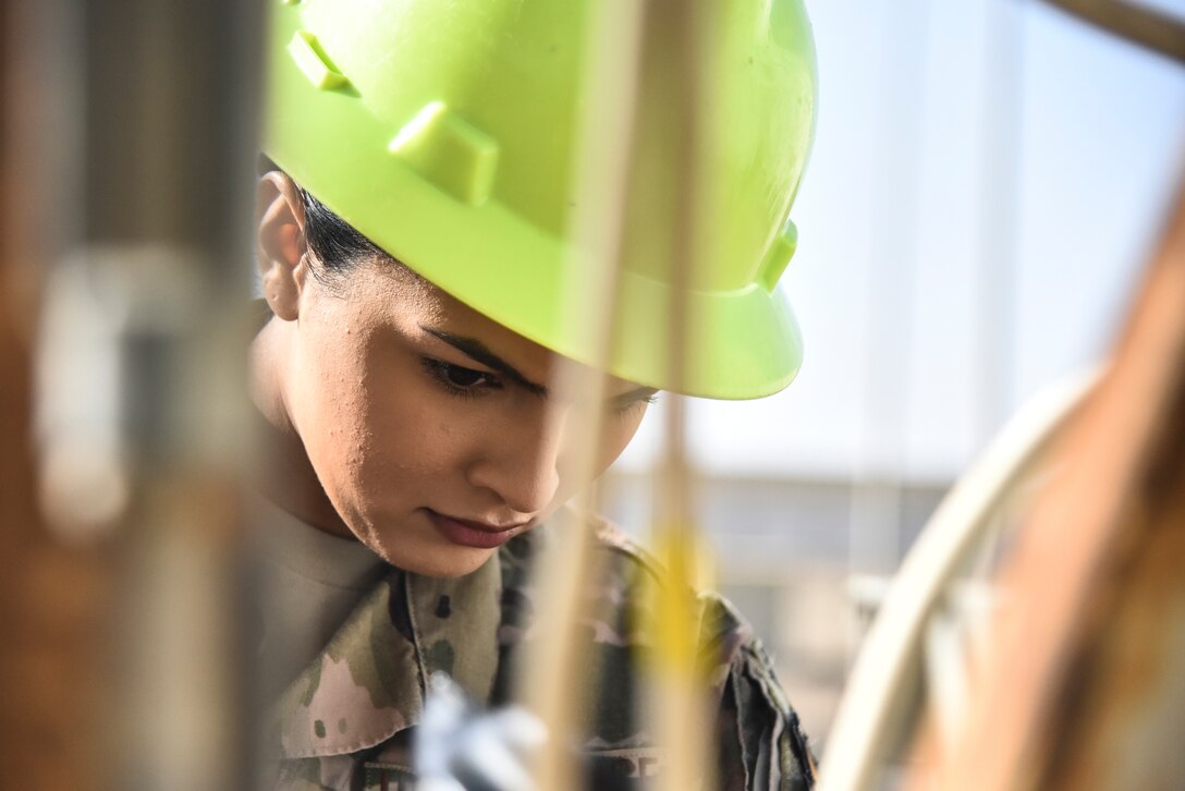 Senior Airman Angelica Gutierrez, 380th Expeditionary Civil Engineer Squadron electrical systems journeyman, identifies wires in a junction box at Al Dhafra Air Base, United Arab Emirates, Feb. 18, 2019. Electrical systems specialists troubleshoot malfunctions using technical orders, manufacturers' handbooks, local procedures, codes, and directives.  (U.S. Air Force photo by Senior Airman Mya M. Crosby)