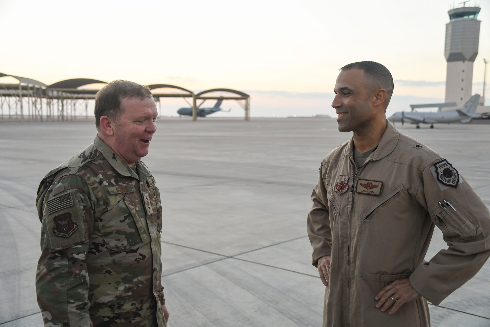 U.S. Air Force Lt. Gen. Richard Scobee, commander of Air Force Reserve Command, shares a story with Brig. Gen. Adrian Spain, 380th Air Expeditionary Wing commander, during his visit to Al Dhafra Air Base, United Arab Emirates, Feb. 13, 2019.