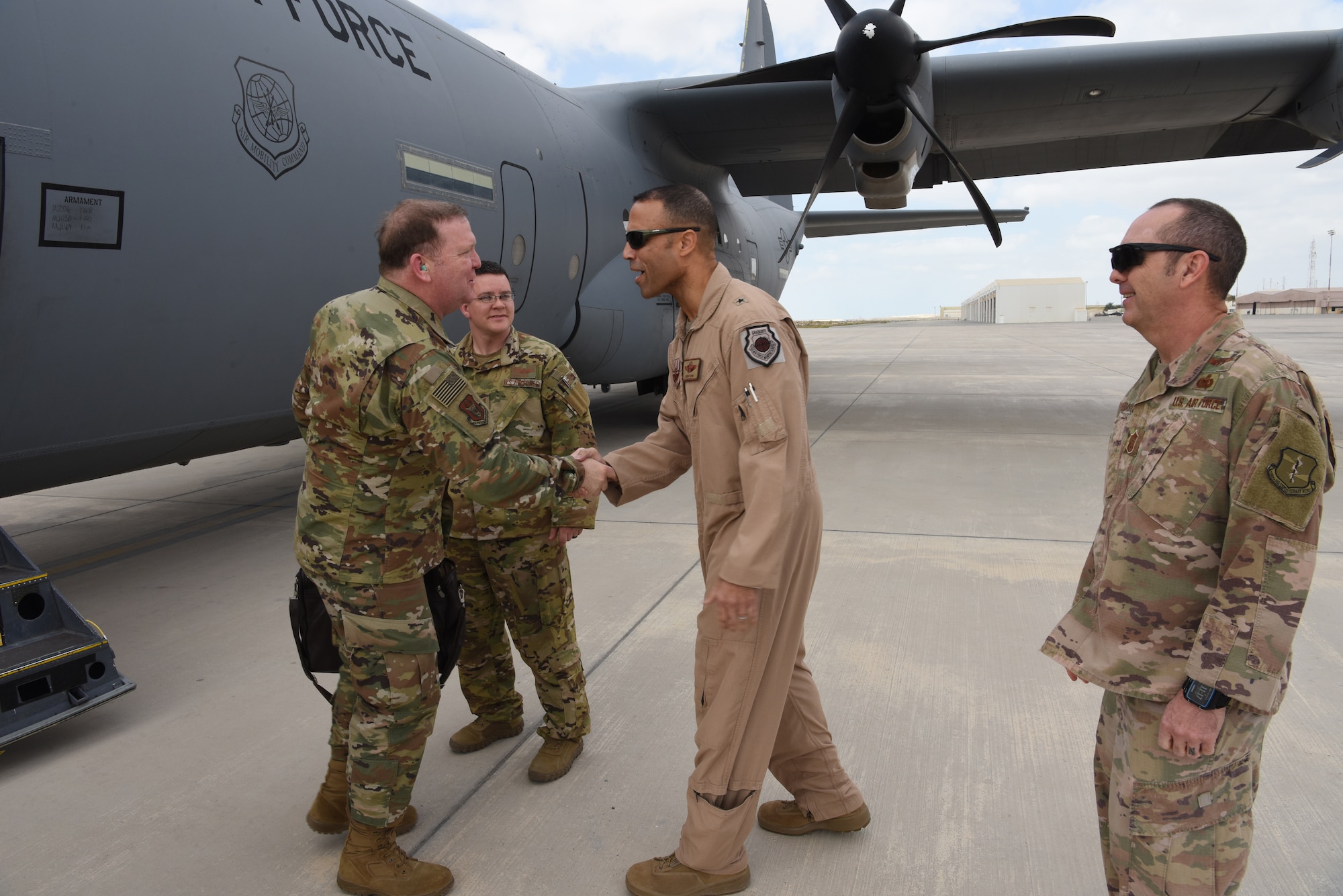 U.S. Air Force Lt. Gen. Richard Scobee, commander of Air Force Reserve Command, is greeted by Brig. Gen. Adrian Spain, 380th Air Expeditionary Wing commander, and Chief Master Sgt. Jared Sebastian, 380th AEW command chief, during his visit to Al Dhafra Air Base, United Arab Emirates, Feb. 13, 2019.