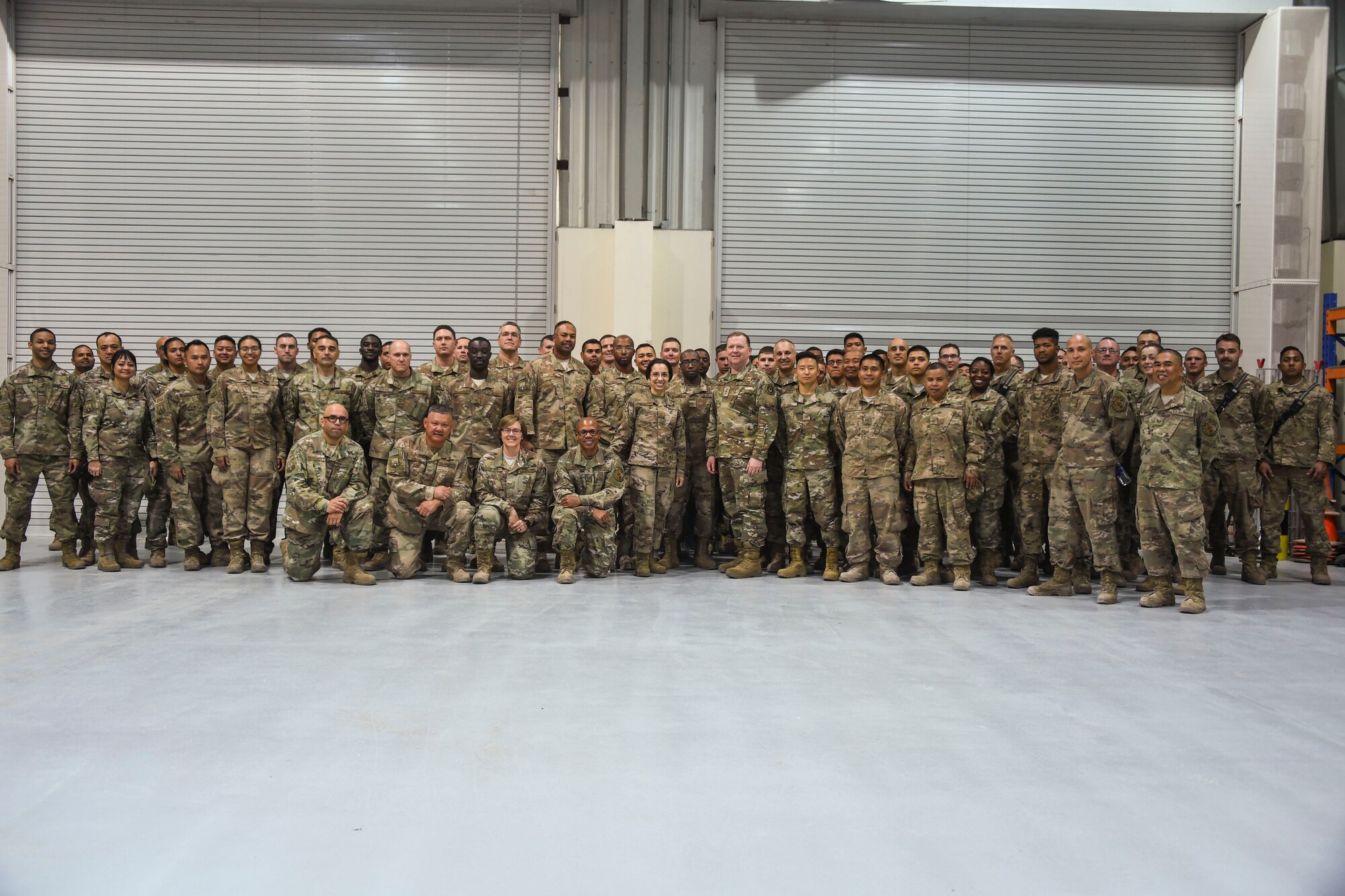 U.S. Air Force Lt. Gen. Richard Scobee, commander of Air Force Reserve Command, and Chief Master Sgt. Ericka Kelly, command chief of AFRC, pose for a photo with members of the 380th Expeditionary Civil Engineer Squadron during their visit to Al Dhafra Air Base, United Arab Emirates, Feb. 13 2019.