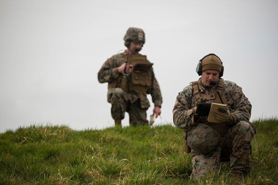 U.S. Marines with Special Purpose Marine Air-Ground Task Force-Crisis Response-Africa 19.1 and Marine Rotational Force-Europe 19.1, Marine Forces Europe and Africa, write down grid coordinates during a close-air-support training event with the British Royal Air Force at Holbeach Range, England, Feb. 18, 2019. SPMAGTF-CR-AF is a rotational force deployed to conduct crisis-response and theater-security operations in Europe and Africa. (U.S. Marine Corps photo by Sgt. Katelyn Hunter)