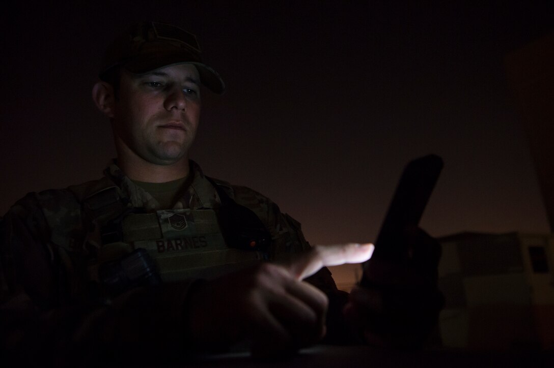 Master Sgt. Jordan Barnes, 379th Expeditionary Security Forces Squadron (ESFS) combined response joint patrol leader, calls members of the Qatar Military Police to establish a meet-up time to conduct a “Spartan Patrol” Jan. 17, 2019, at Al Udeid Air Base, Qatar. Barnes works side-by-side with Qatar Military Police (QMP) to conduct installation perimeter checks. Together, members of 379th ESFS and QMP ensure assets and personnel are safe at Al Udeid, and there are no vulnerabilities in the installation’s perimeter. (U.S. Air Force photo by Tech. Sgt. Christopher Hubenthal)