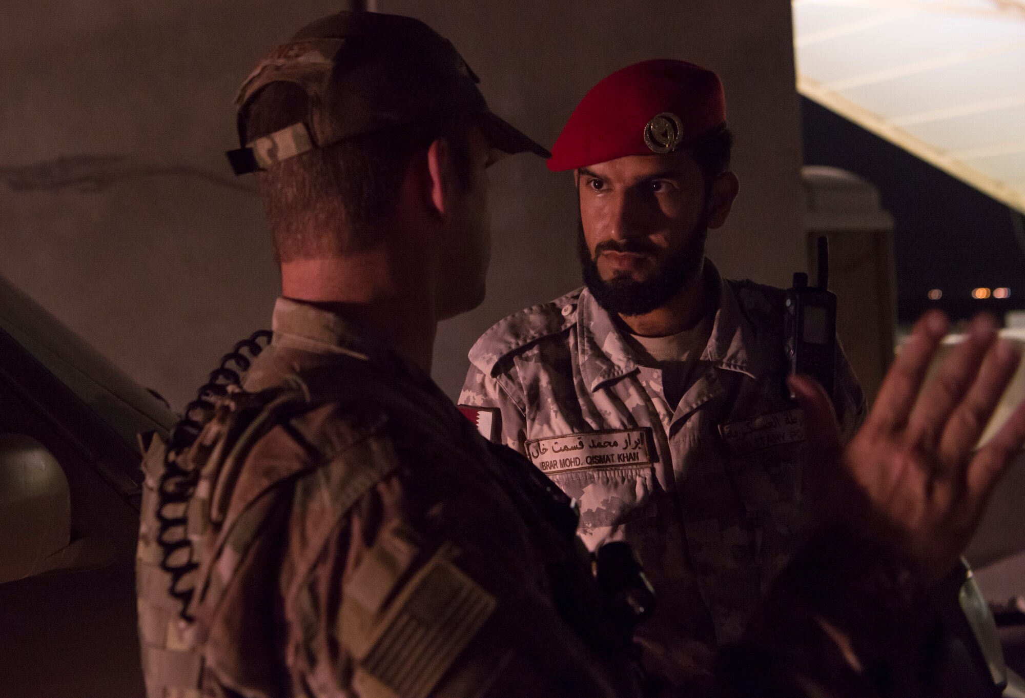 Master Sgt. Jordan Barnes, left, 379th Expeditionary Security Forces Squadron (ESFS) combined response joint patrol leader, talks to Qatar Military Police (QMP) Soldier Ibrar Mohd. Qismat Khan, prior to conducting a “Spartan Patrol” Jan. 17, 2019, at Al Udeid Air Base, Qatar. Barnes conducts Spartan Patrols, where he works side-by-side with the QMP to conduct installation perimeter checks. Together, members of 379th ESFS and QMP ensure assets and personnel are safe at Al Udeid, and there are no vulnerabilities in the installation’s perimeter. (U.S. Air Force photo by Tech. Sgt. Christopher Hubenthal)