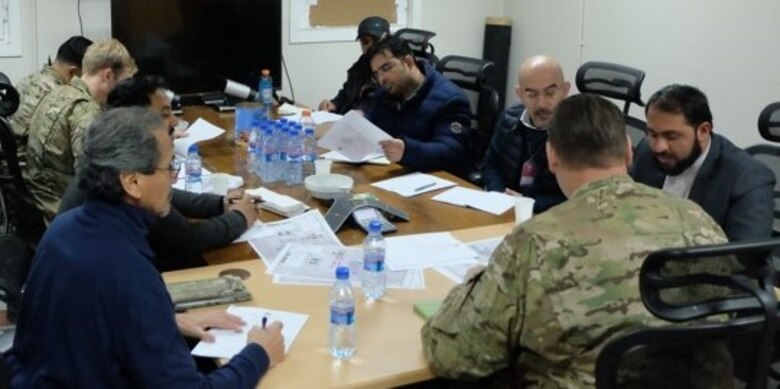 Project Engineer Brian Cagle at the head of table and Quality Assurance Representative Tony Soliz, left from the Marmal Project Delivery Platform office in Afghanistan meet with the Biltek Company in efforts to begin the Camp John Pratt Construction project.
