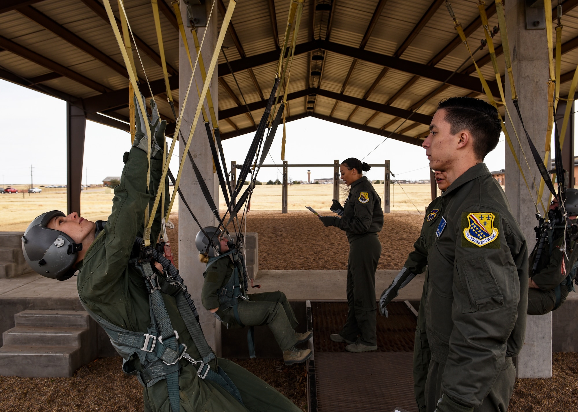 Pilot Training Next program students, left, simulate being in a parachute while 82nd Aerospace Medical Squadron physiology technicians supervise them at Sheppard Air Force Base, Texas, Jan. 29, 2019. This is the same training that the Euro-Nato Joint Jet Pilot Training program students with the 80th Flying Training Wing go through during their stay at Sheppard. (U.S. Air Force photo by Airman 1st Class Pedro Tenorio)