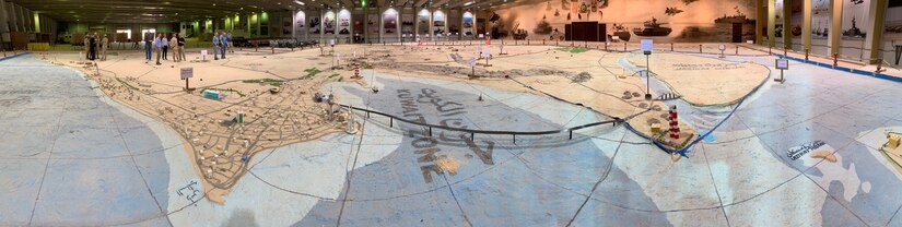 Soldiers with the Minnesota National Guard’s 34th Red Bull Infantry Division walk through a large-scale terrain model of Kuwait at a Kuwait Land Force compound Feb. 20, 2019. The Red Bulls partnered with their Kuwaiti hosts to learn about the history of Saddam Hussein ’s invasion of Kuwait and the national and international response that liberated the nation. The Soldiers, currently deployed to the region as Task Force Spartan, also visited the Al Qurain Marytr Museum to discover one story of a battle between local resistance fighters and the invading forces.