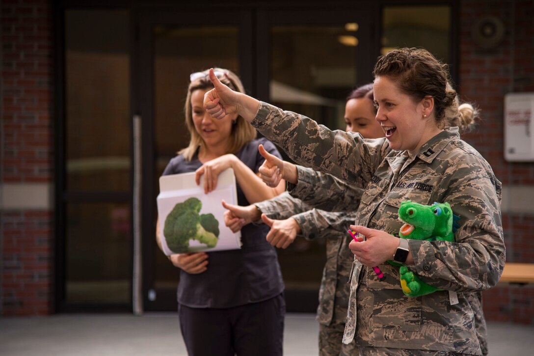 Members of the 23d Aerospace Medical Squadron dental clinic speak with children from the Child Development Center about the importance of dental hygiene for National Children's Dental Health Month, Feb. 22, 2019, at Moody Air Force Base, Ga. This month-long national health observance brings together thousands of dedicated professionals, healthcare providers and educators to promote the benefits of good oral health to children. (U.S. Air Force Photo by Andrea Jenkins)