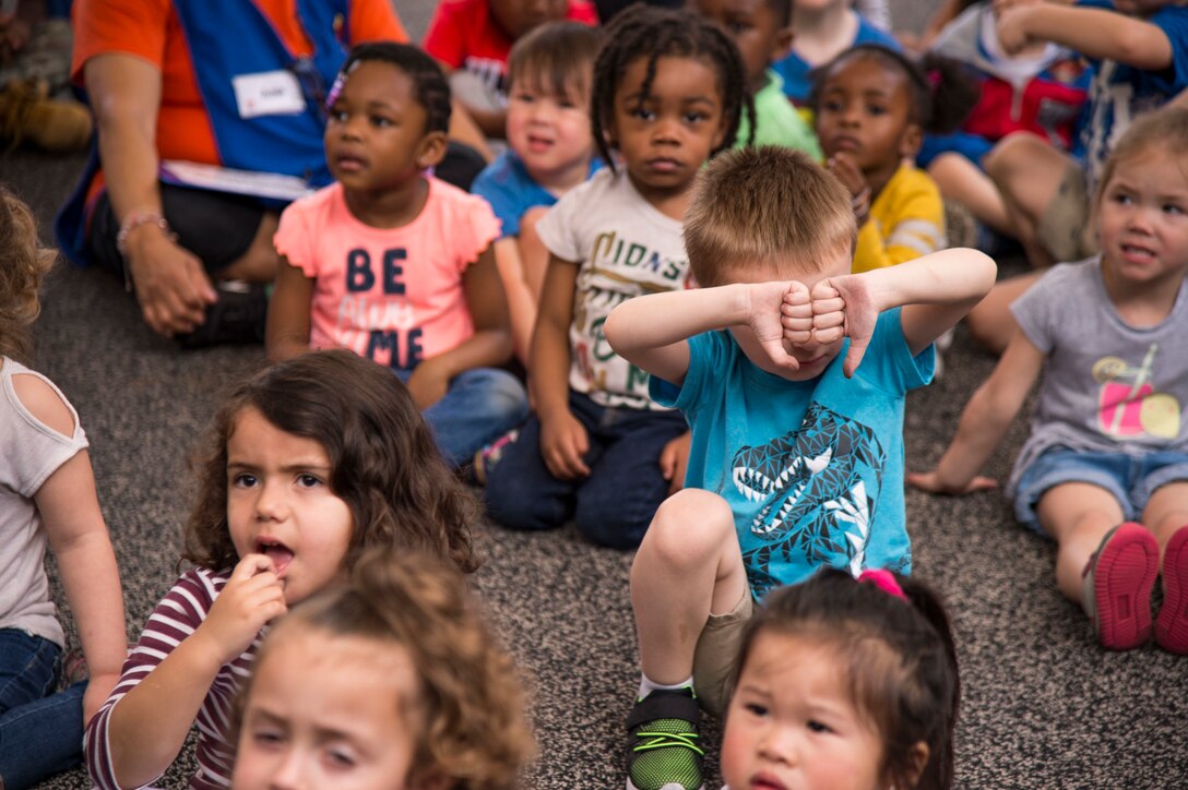 A child from the Child Development Center gives two thumbs down in response to a question about candy, Feb. 22, 2019, at Moody Air Force Base, Ga. Members of the 23d Aerospace Medical Squadron dental clinic spoke with children from the Child Development Center about the importance of dental hygiene for National Children's Dental Health Month. This month-long national health observance brings together thousands of dedicated professionals, healthcare providers and educators to promote the benefits of good oral health to children. (U.S. Air Force Photo by Andrea Jenkins)