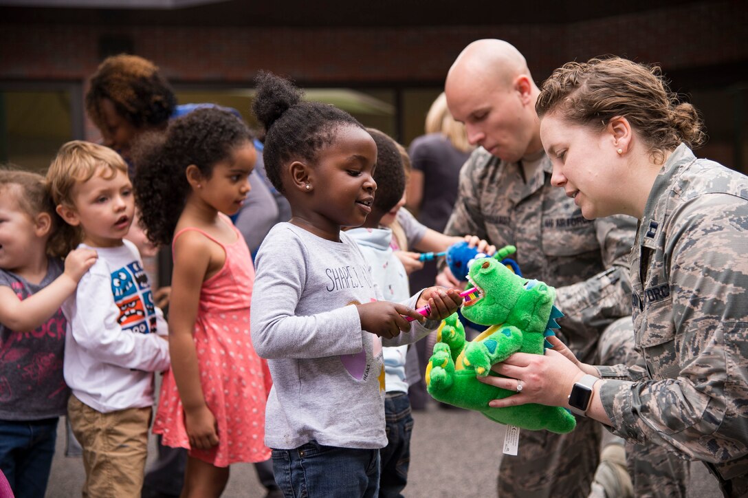 Members of the 23d Aerospace Medical Squadron dental clinic show children from the Child Development Center how to properly brush their teeth, Feb. 22, 2019, at Moody Air Force Base, Ga. Members of the 23d Aerospace Medical Squadron dental clinic spoke with children from the Child Development Center about the importance of dental hygiene for National Children's Dental Health Month. This month-long national health observance brings together thousands of dedicated professionals, healthcare providers and educators to promote the benefits of good oral health to children. (U.S. Air Force Photo by Andrea Jenkins)