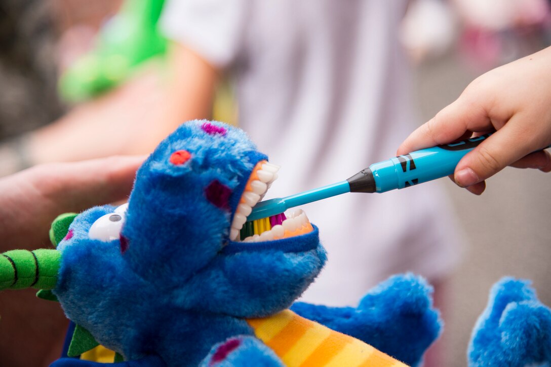A child brushes the teeth on a stuffed animal at the Child Development Center, Feb. 22, 2019, at Moody Air Force Base, Ga. Members of the 23d Aerospace Medical Squadron dental clinic spoke with children from the Child Development Center about the importance of dental hygiene for National Children's Dental Health Month. This month-long national health observance brings together thousands of dedicated professionals, healthcare providers and educators to promote the benefits of good oral health to children. (U.S. Air Force Photo by Andrea Jenkins)