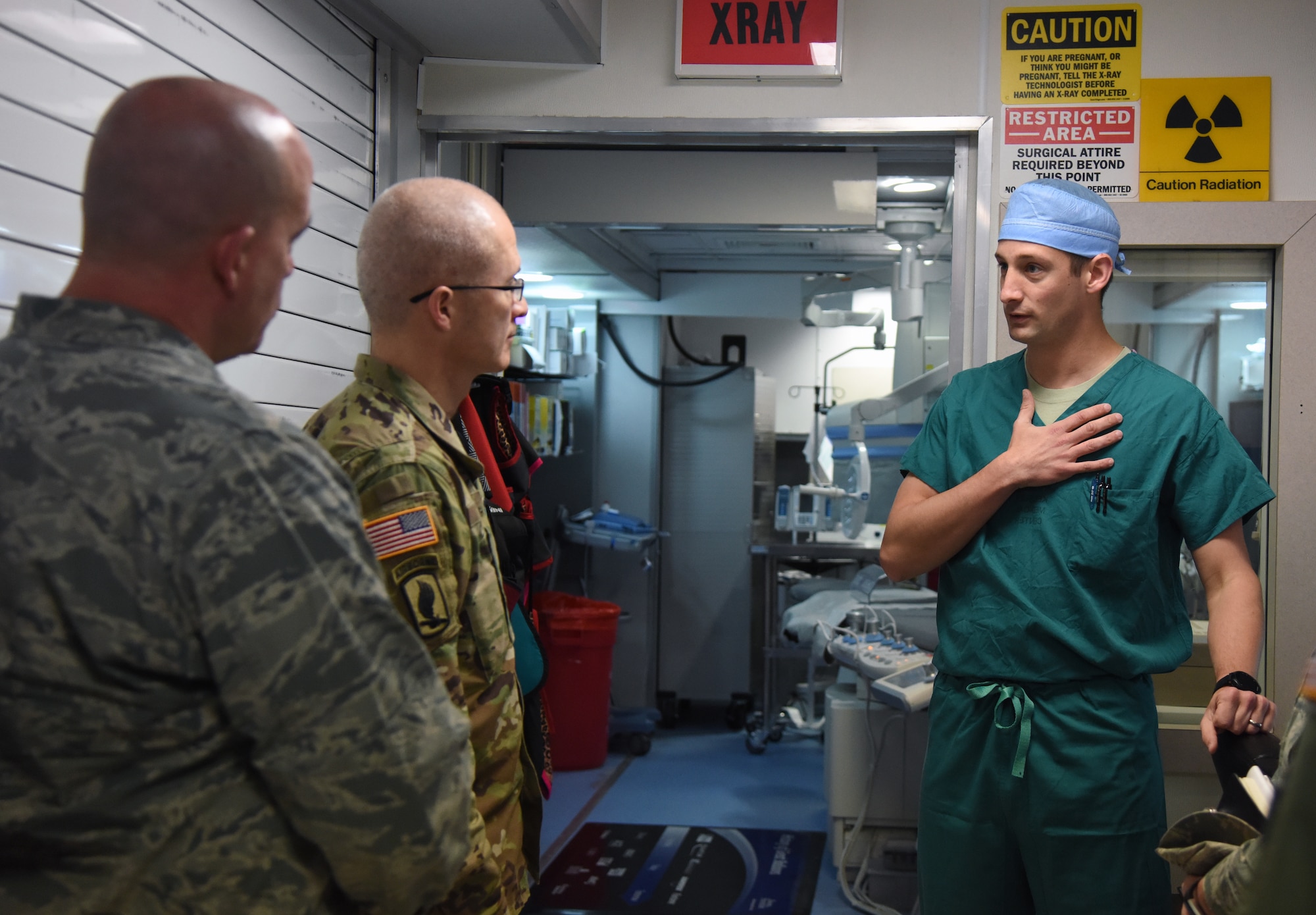 U.S. Air Force Maj. David Russo, 81st Medical Operations Squadron interventional cardiologist, discusses the mobile catheterization lab capabilities with U.S. Army Maj. Gen. Ronald Place, Defense Health Agency, director for the National Capital Region Medical Directorate and Transition Intermediate Management Organization, during an immersion tour inside the Keesler Medical Center at Keesler Air Force Base, Mississippi, Feb. 13, 2019. The purpose of Place's two-day visit was to become more familiar with the medical center's mission capabilities and to receive the status of the 81st Medical Group's transition under DHA. (U.S. Air Force photo by Kemberly Groue)