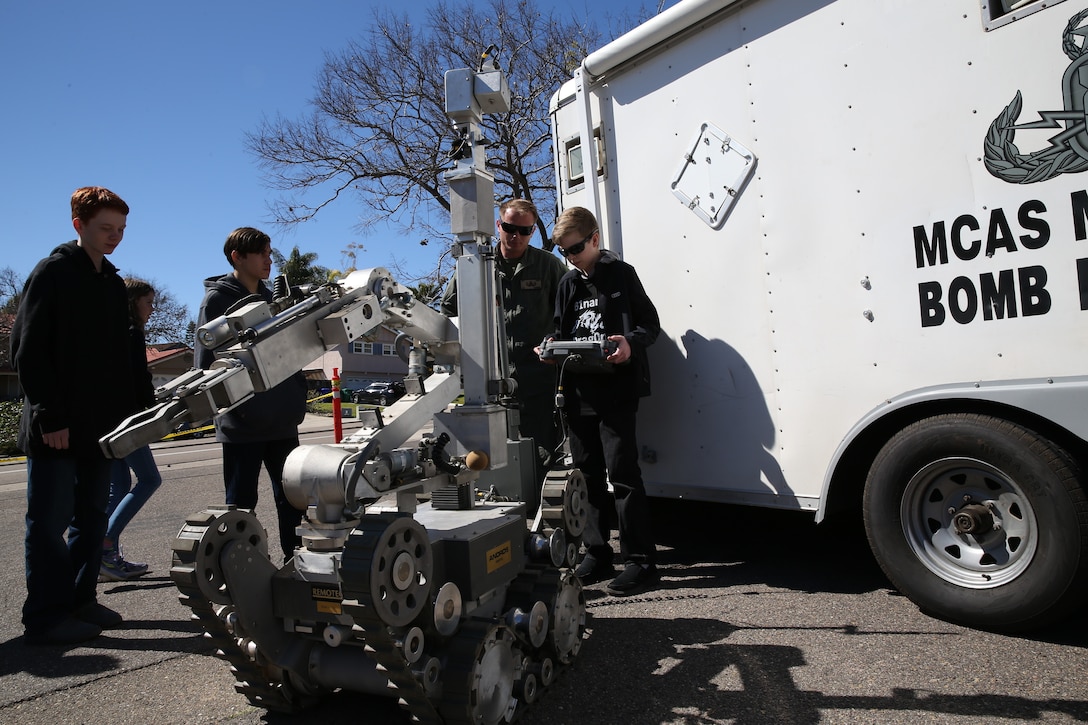 San Diego community members interact with Sgt. Robert Tenbrink, an Explosive Ordnance Disposal (EOD) Technician with Headquarters and Headquarters Squadron, during the 2nd Annual Robotic Showcase Extravaganza 2019 in San Diego, Calif., Feb. 23. The Marines attended this event to teach students about robotics as well as foster cohesion with the surrounding community. (U.S. Marine Corps photo by Sgt. Sarah Ralph)