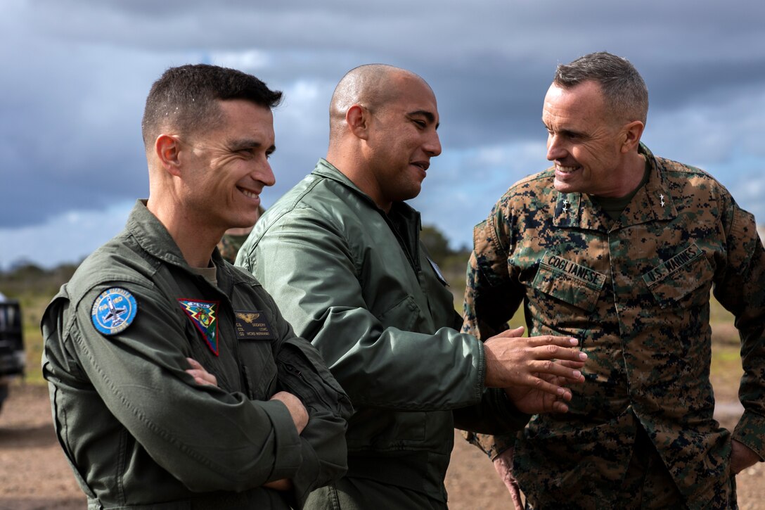 Maj. Gen. Vincent A. Coglianese, commander, Marine Corps Installations Command, right, speaks with GySgt. Gabriel Rojo, an Aircraft Rescue and Firefighting (ARFF) Marine with Marine Corps Air Station Miramar ARFF, center, and Col. Charles Dockery, the MCAS Miramar commanding officer, left, about the success of the P-19 Firetruck at MCAS Miramar, Calif., Feb. 21. Coglianese visited MCAS Miramar to tour and observe the current innovative projects taking place on the installation. (U.S. Marine Corps photo by Sgt. Jake McClung)