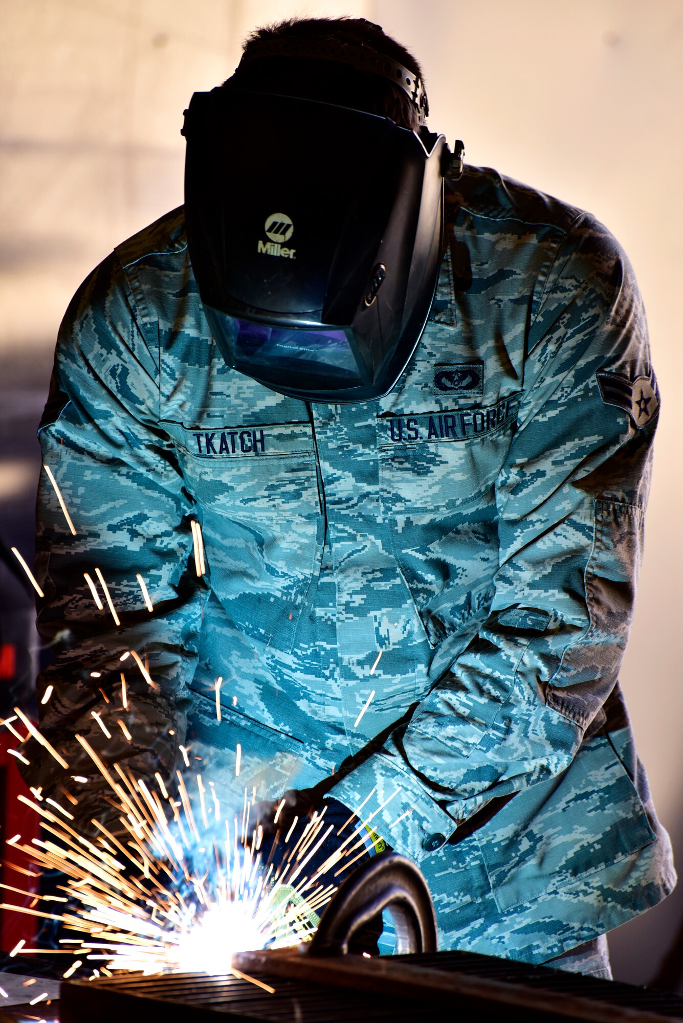 Airman welds metal grate