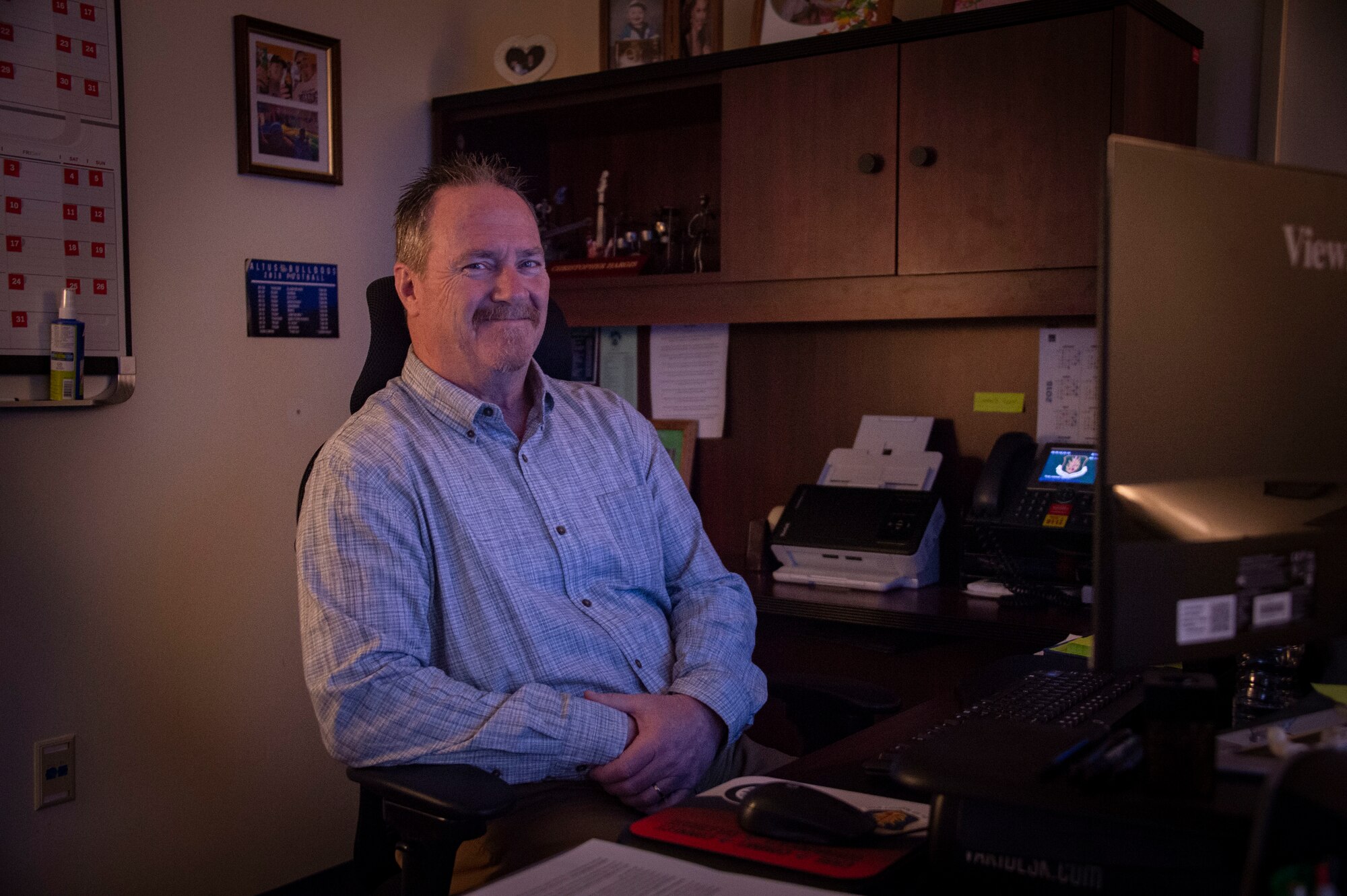 Chris Hargis, the community support coordinator assigned to the 97th Air Mobility Wing, sits at his desk