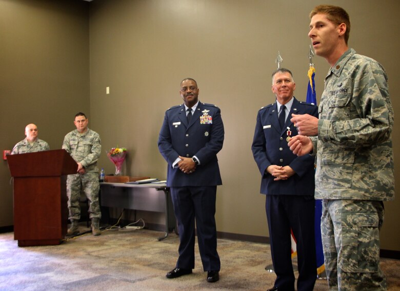 The 932nd Airlift Wing Director of Staff, Maj. Luke Barker, speaks about retiring Chaplain (Lt. Col.) William Thornton before a special gift presentation as part of the overall retirement ceremony held Feb. 9, 2019, at Scott Air Force Base, Illinois.  At center is former vice commander of the wing, Col. Esteban Ramirez, who was the guest speaker for the event.  Friends and family gathered from several states to wish Colonel Thornton well on his special day.  (U.S. Air Force photo by Lt. Col. Stan Paregien)