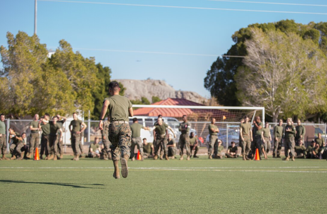 A U.S. Marine stationed at Marine Corps Air Station (MCAS) Yuma, sprints to his team after spinning his head on a bat as part of the Dizzy Izzy event during the 3rd Annual Super Squadron at the MCAS Yuma Memorial Sports Complex January 11, 2019. The Super Squadron is a friendly competition between the various units on station, designed to help strengthen teamwork as well as boost station morale. Marine Air Control Squadron (MACS) 1 won the competition for the 3rd year in a row, with Headquarters & Headquarters Squadron (H&HS) coming in second. (U.S. Marine Corps photo by Cpl. Sabrina Candiaflores)