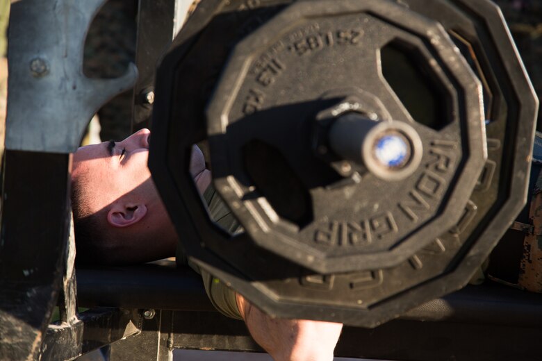 A U.S. Marine stationed at Marine Corps Air Station (MCAS) Yuma, does a bench press as part of the 3rd Annual Super Squadron event at the MCAS Yuma Memorial Sports Complex January 11, 2019. The Super Squadron is a friendly competition between the various units on station, designed to help strengthen teamwork as well as boost station morale. Marine Air Control Squadron (MACS) 1 won the competition for the 3rd year in a row, with Headquarters & Headquarters Squadron (H&HS) coming in second. (U.S. Marine Corps photo by Cpl. Sabrina Candiaflores)