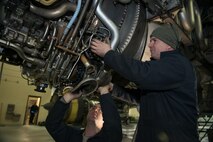 Crew chiefs assigned to the 5th Maintenance Squadron lower the vertical stabilizer on a B-52H Stratofortress at Minot Air Force Base, North Dakota, Feb. 10, 2019.