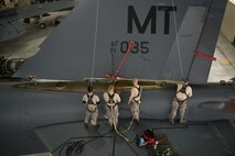 Crew chiefs assigned to the 5th Maintenance Squadron lower the vertical stabilizer on a B-52H Stratofortress at Minot Air Force Base, North Dakota, Feb. 10, 2019.