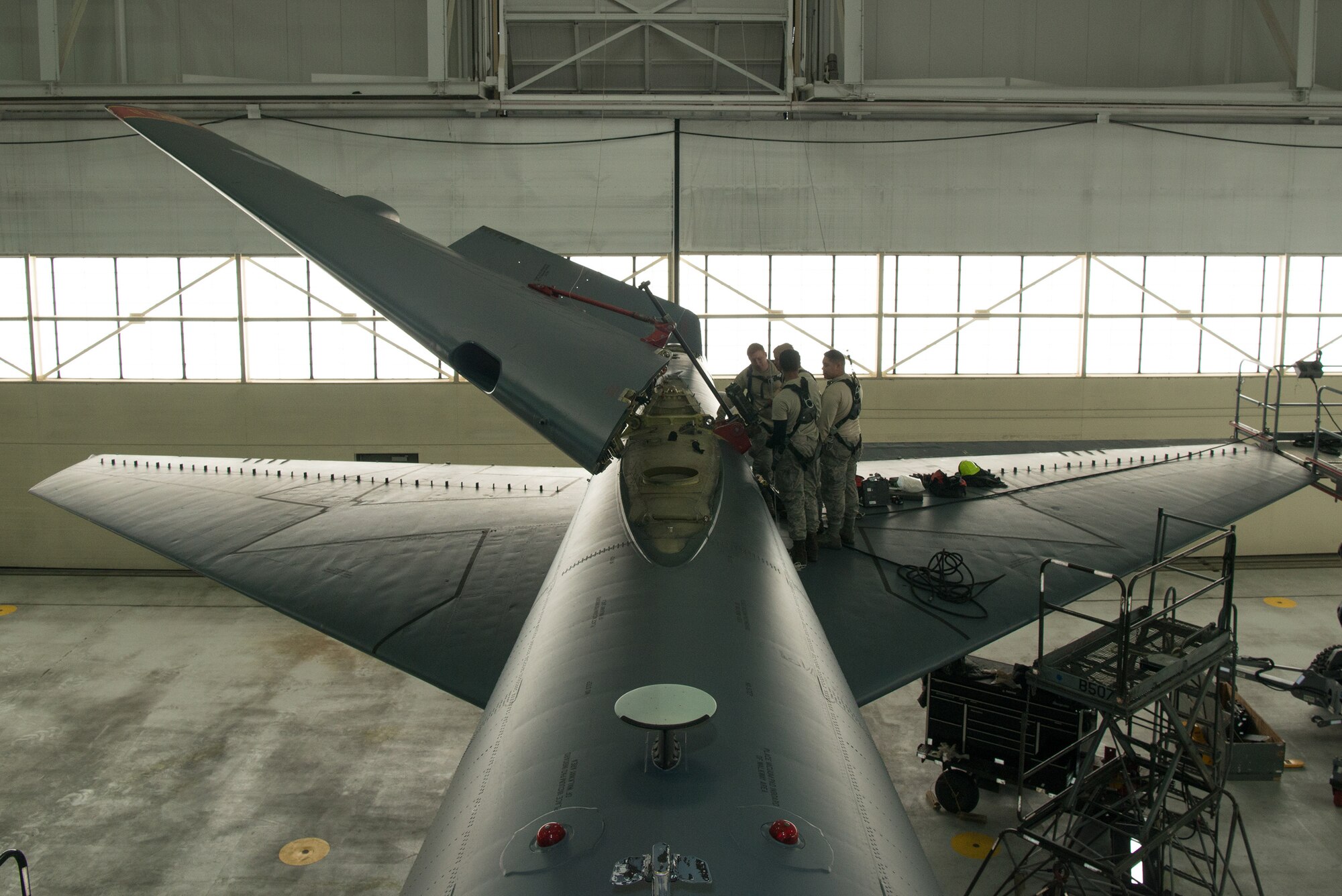 Crew chiefs assigned to the 5th Maintenance Squadron lower the vertical stabilizer on a B-52H Stratofortress at Minot Air Force Base, North Dakota, Feb. 10, 2019.