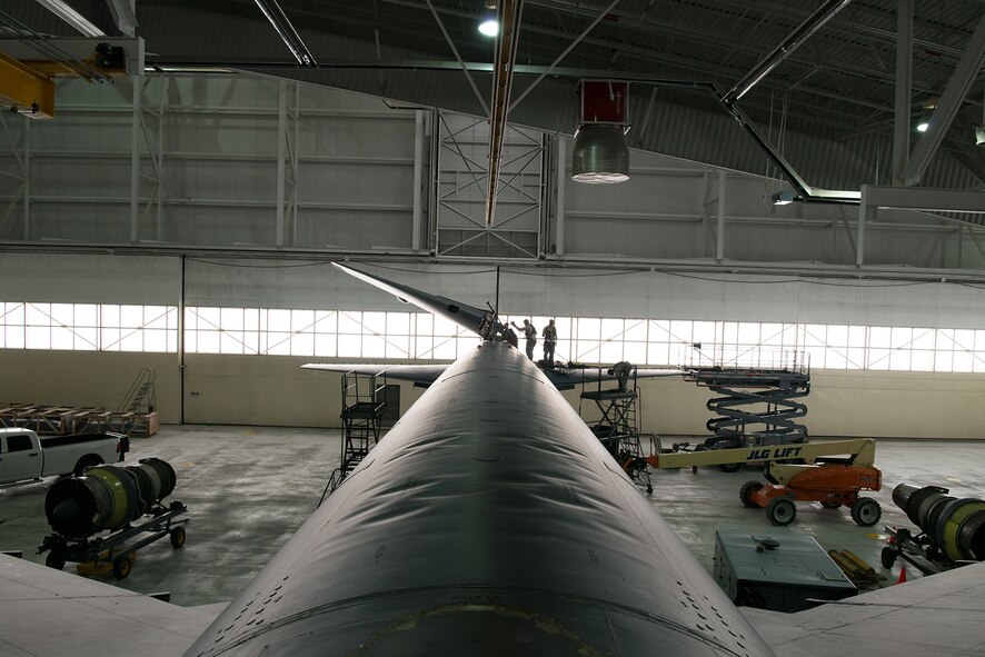 Crew chiefs assigned to the 5th Maintenance Squadron lower the vertical stabilizer on a B-52H Stratofortress at Minot Air Force Base, North Dakota, Feb. 10, 2019.