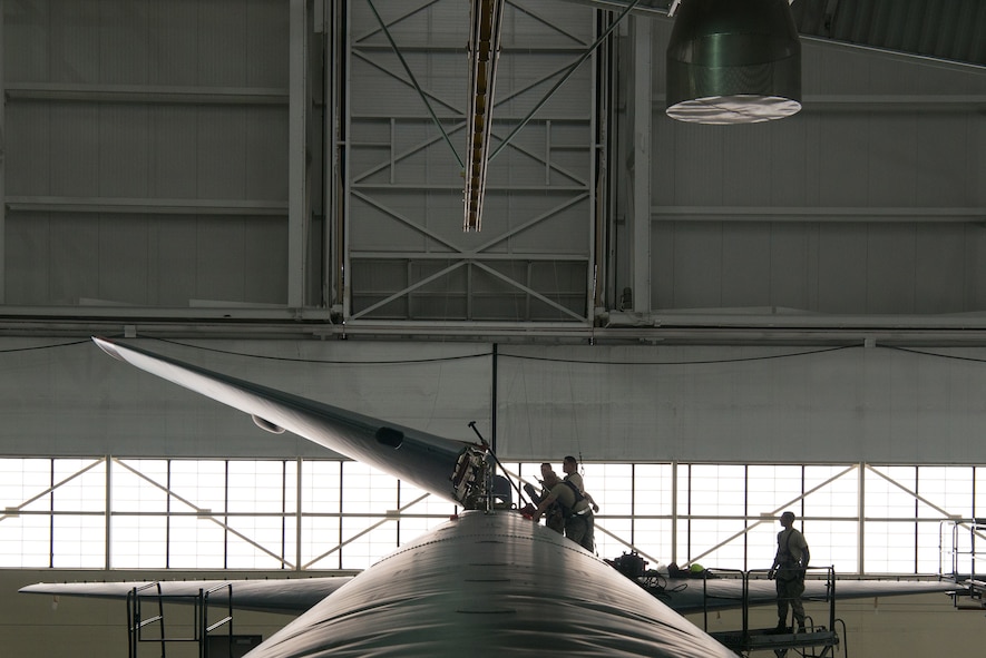 Crew chiefs assigned to the 5th Maintenance Squadron lower the vertical stabilizer on a B-52H Stratofortress at Minot Air Force Base, North Dakota, Feb. 10, 2019.