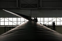 Crew chiefs assigned to the 5th Maintenance Squadron lower the vertical stabilizer on a B-52H Stratofortress at Minot Air Force Base, North Dakota, Feb. 10, 2019.