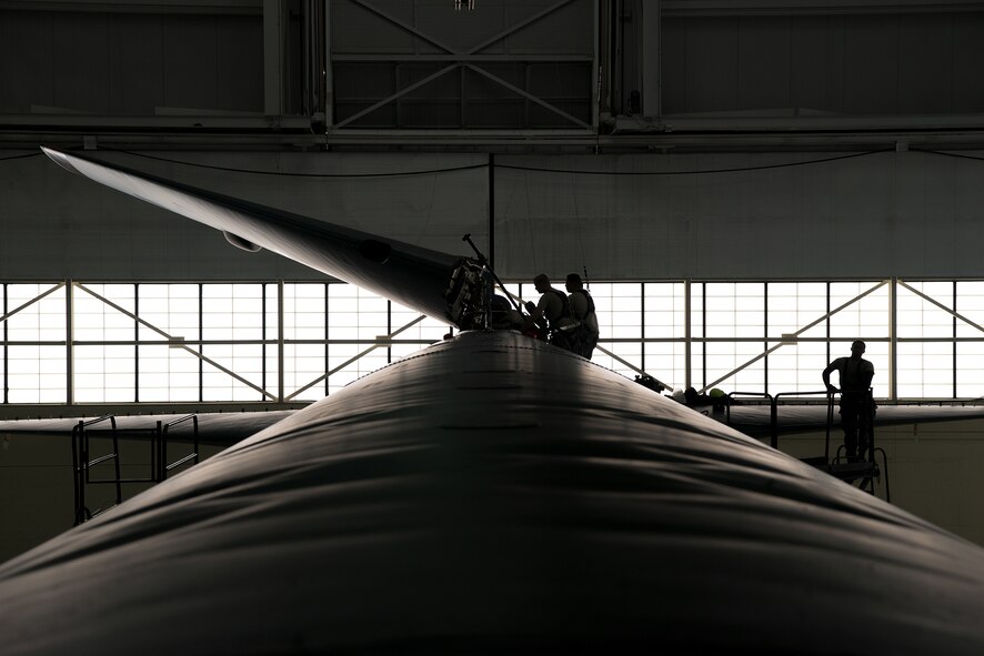 Crew chiefs assigned to the 5th Maintenance Squadron lower the vertical stabilizer on a B-52H Stratofortress at Minot Air Force Base, North Dakota, Feb. 10, 2019.