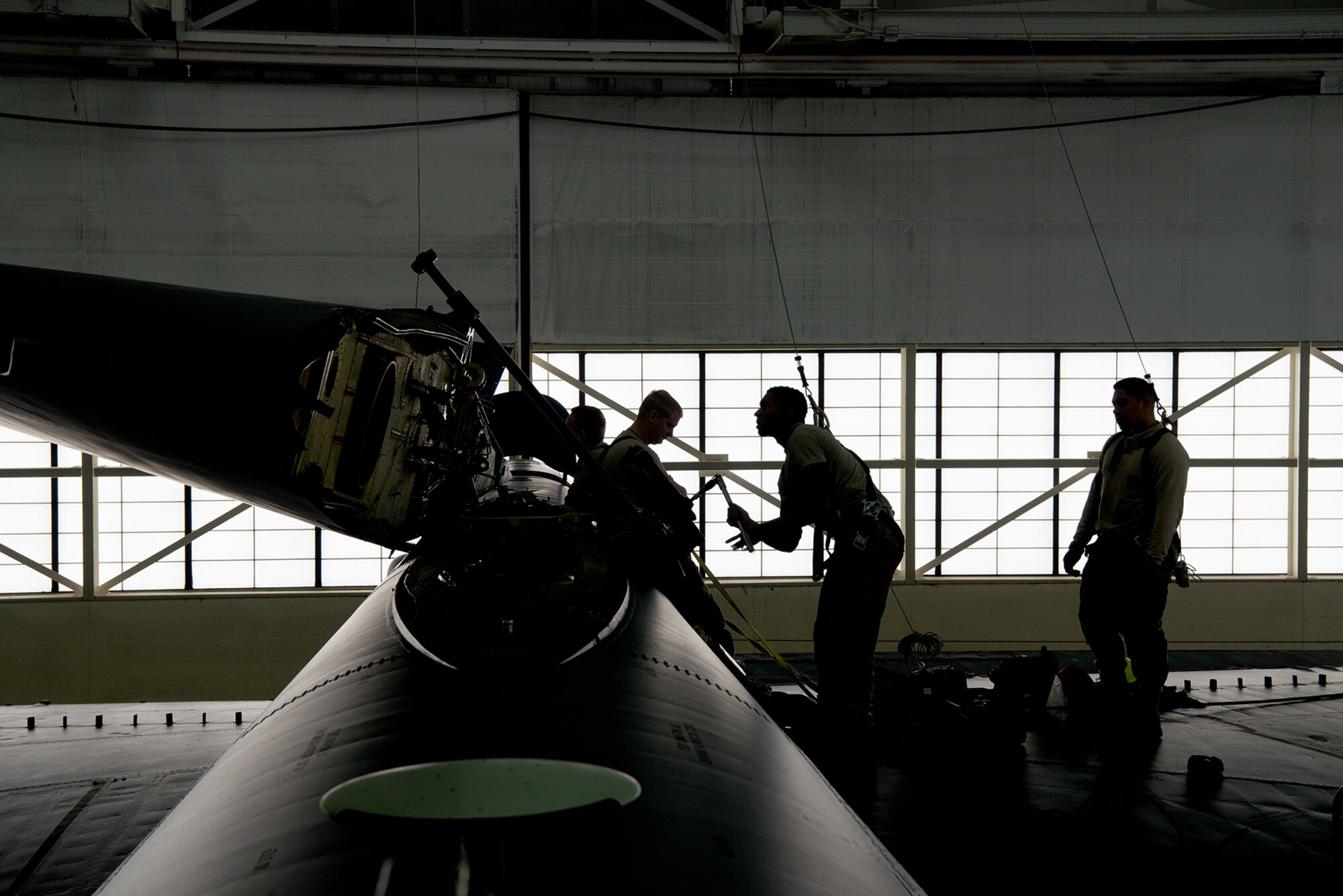 Crew chiefs assigned to the 5th Maintenance Squadron lower the vertical stabilizer on a B-52H Stratofortress at Minot Air Force Base, North Dakota, Feb. 10, 2019.