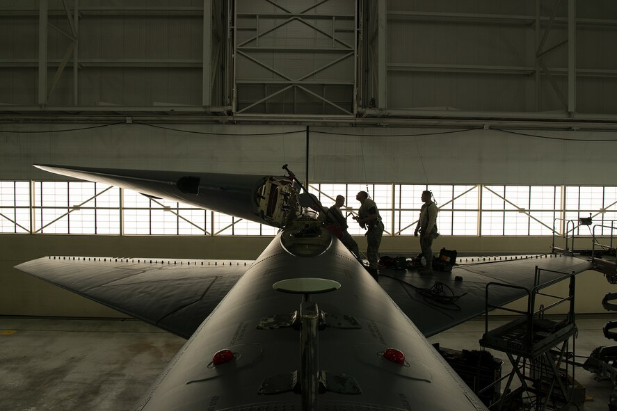 Crew chiefs assigned to the 5th Maintenance Squadron lower the vertical stabilizer on a B-52H Stratofortress at Minot Air Force Base, North Dakota, Feb. 10, 2019.