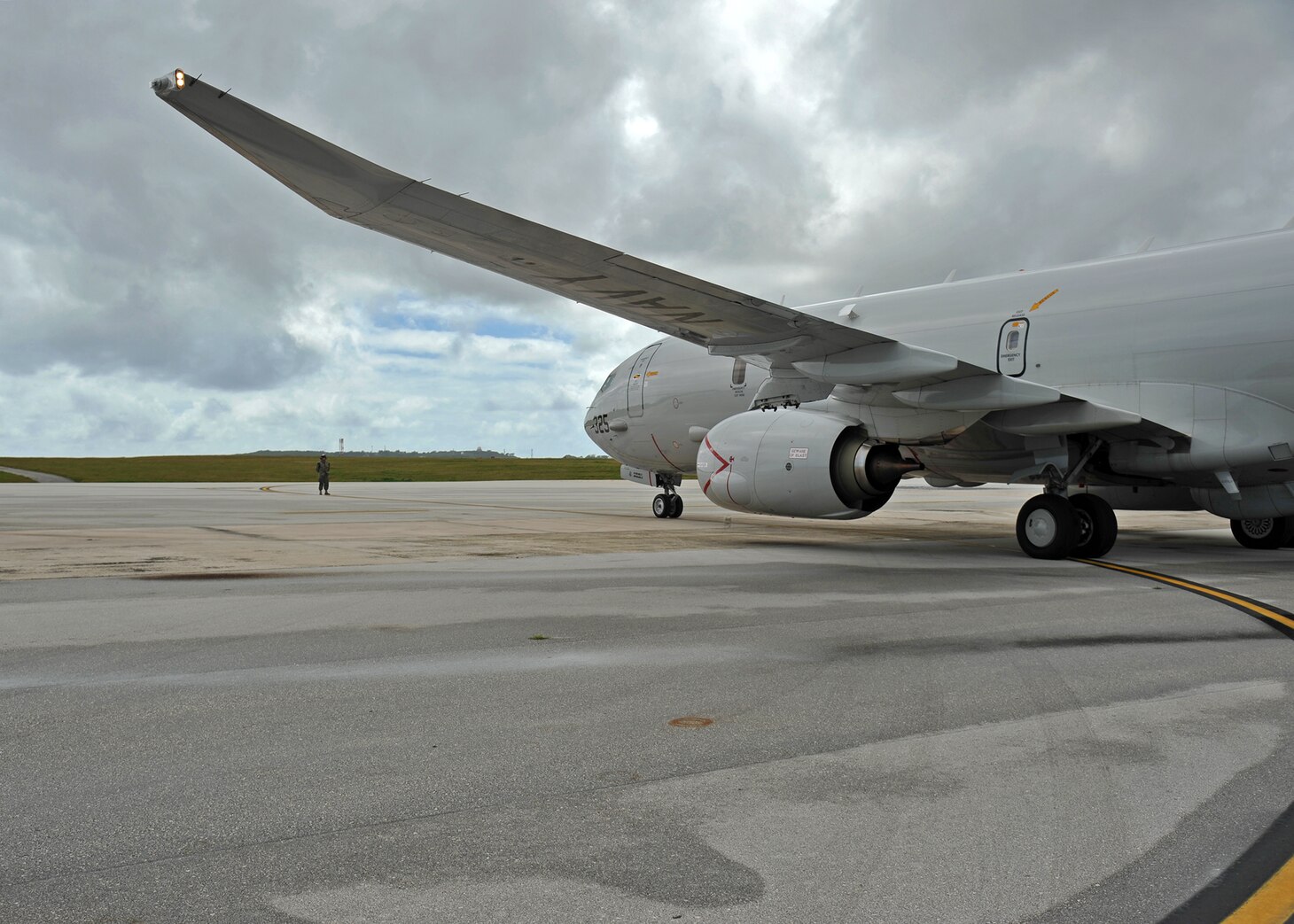 Airman Joseph Harding, assigned to the "Golden Swordsmen" of Patrol Squadron (VP) 47, guides a VP-47 P-8A Poseidon to park following flight operations. Exercise Sea Dragon is an annual, multilateral exercise that stresses coordinated anti-submarine warfare prosecution against both simulated and live targets.