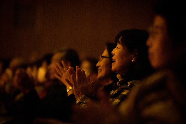 Audience members clap along to the music performed by the USAF Band of the Pacific during the Japan-U.S. Joint Concert Feb. 24, 2019, at the Hamura Learning Center in Hamura, Tokyo, Japan. Members of the USAF Band of the Pacific and the Hamura Daiichi Jr. High School Band mixed and played as one for the event. (U.S. Air Force photo by Senior Airman Donald Hudson)