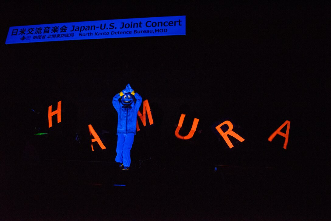 The Hamura Daiichi Jr. High School band perform a musical number from Disney’s Aladdin while actors perform a choreographed dance during the Japan-U.S. Joint Concert Feb. 24, 2019, at the Hamura Learning Center in Hamura, Tokyo, Japan. Members of the USAF Band of the Pacific and the Hamura Daiichi Jr. High School Band mixed and played as one for the event. (U.S. Air Force photo by Senior Airman Donald Hudson)