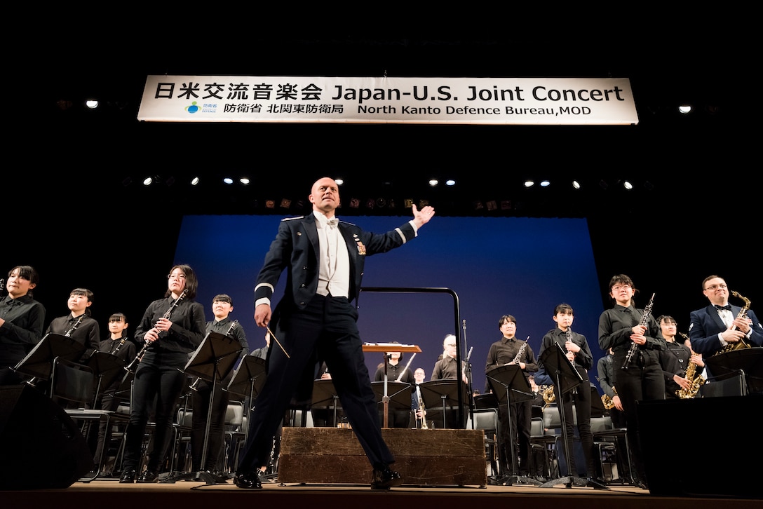 Maj. Michael Hoerber, USAF Band of the Pacific commander and conductor, arrives on stage during the Japan-U.S. Joint Concert Feb. 24, 2019, at the Hamura Learning Center in Hamura, Tokyo, Japan. This year marks the 11th annual Japan-U.S. Joint Concert event organized by the North Kanto Defense Bureau Ministry of Defense and acts as an avenue in strengthening the partnerships and alliances between Yokota Air Base and the local communities. (U.S. Air Force photo by Senior Airman Donald Hudson)