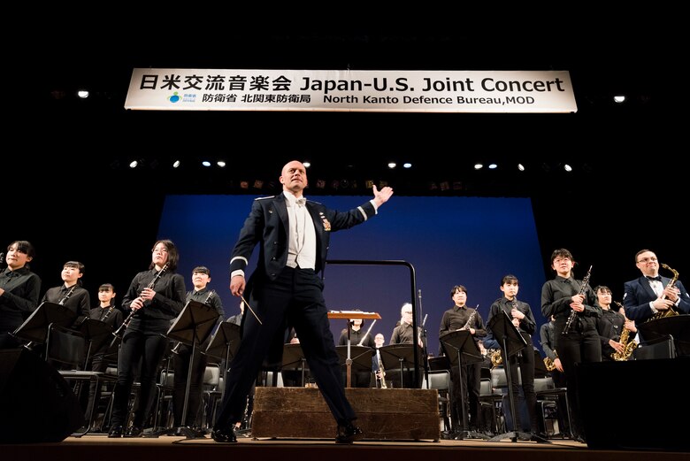 Maj. Michael Hoerber, USAF Band of the Pacific commander and conductor, arrives on stage during the Japan-U.S. Joint Concert Feb. 24, 2019, at the Hamura Learning Center in Hamura, Tokyo, Japan. This year marks the 11th annual Japan-U.S. Joint Concert event organized by the North Kanto Defense Bureau Ministry of Defense and acts as an avenue in strengthening the partnerships and alliances between Yokota Air Base and the local communities. (U.S. Air Force photo by Senior Airman Donald Hudson)