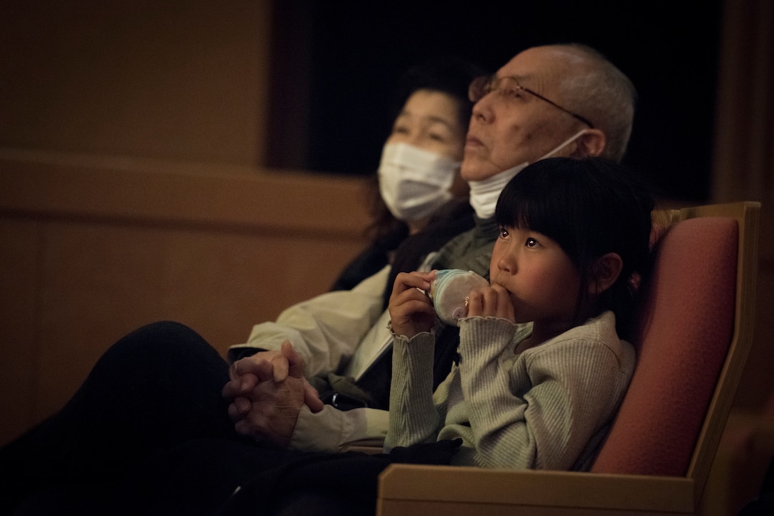 A young concert goer watches the performance during the Japan-U.S. Joint Concert Feb. 24, 2019, at the Hamura Learning Center in Hamura, Tokyo, Japan. This year marks the 11th annual Japan-U.S. Joint Concert event organized by the North Kanto Defense Bureau Ministry of Defense and acts as an avenue in strengthening the partnerships and alliances between Yokota Air Base and the local communities. (U.S. Air Force photo by Senior Airman Donald Hudson)