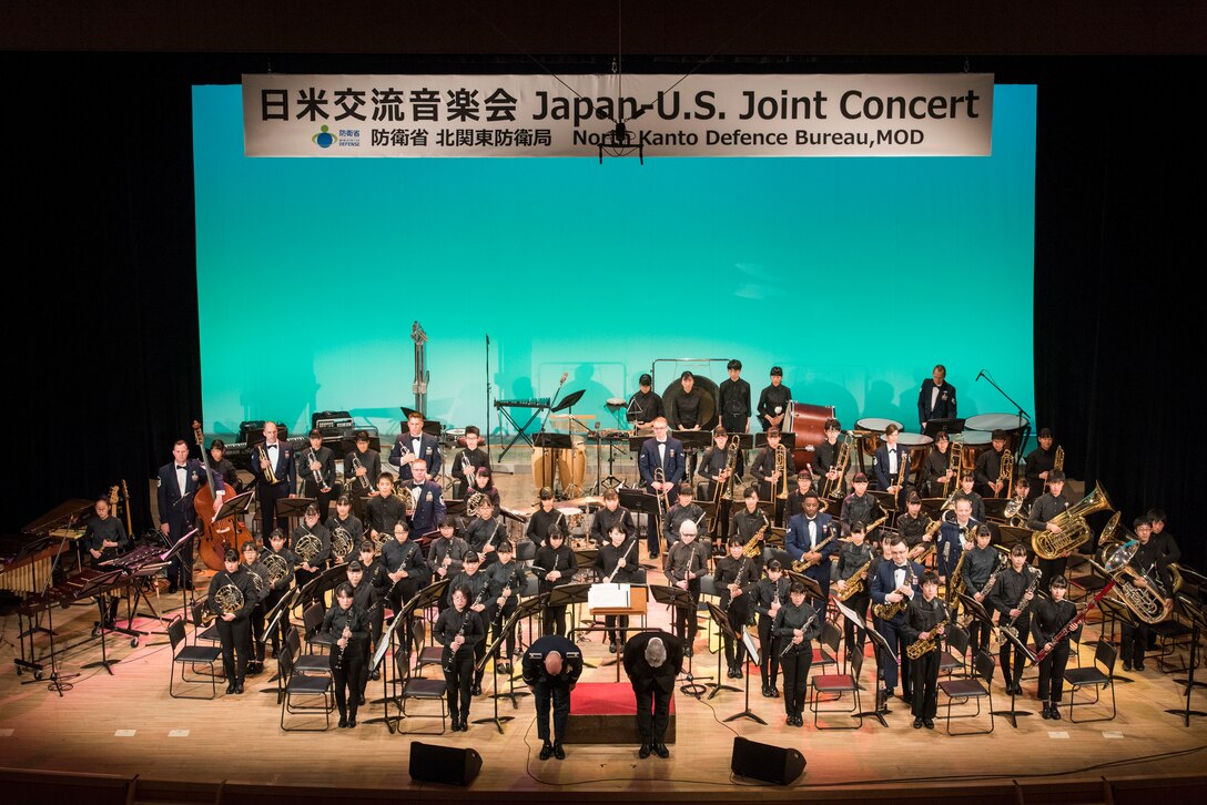 The conductors take a bow at the conclusion of the Japan-U.S. Joint Concert Feb. 24, 2019, at the Hamura Learning Center in Hamura, Tokyo, Japan. Members of the USAF Band of the Pacific and the Hamura Daiichi Jr. High School Band mixed and played as one for the event. (U.S. Air Force photo by Senior Airman Donald Hudson)