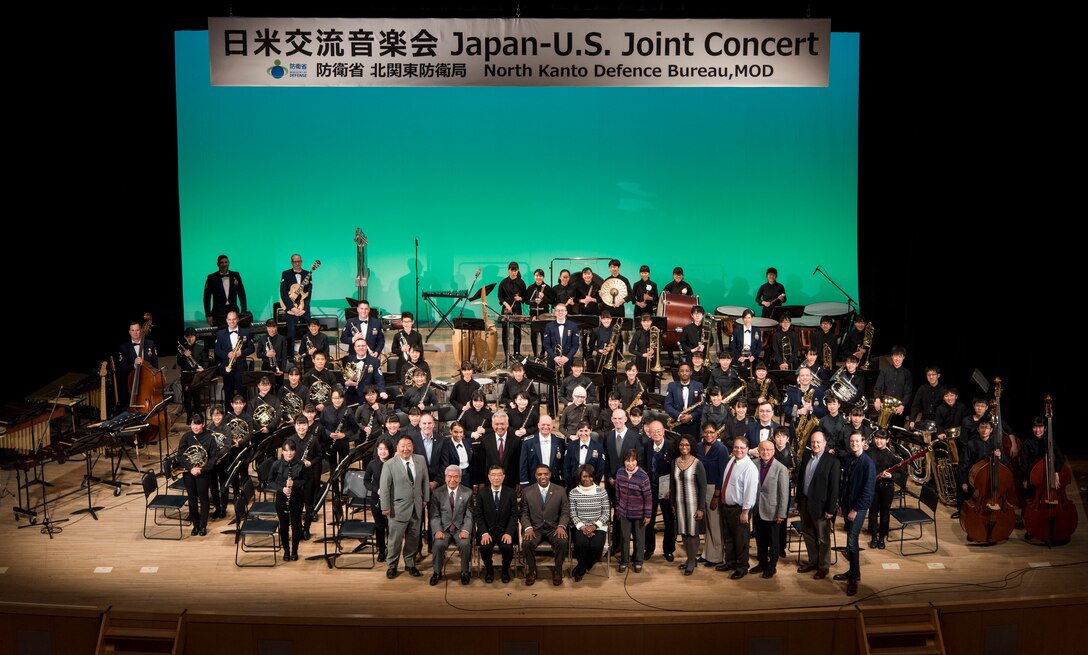 The special guests join the band for a group photo after a Japan-U.S. Joint Concert Feb. 24, 2019, at the Hamura Learning Center in Hamura, Tokyo, Japan. This year marks the 11th annual Japan-U.S. Joint Concert event organized by the North Kanto Defense Bureau Ministry of Defense and acts as an avenue in strengthening the partnerships and alliances between Yokota Air Base and the local communities. (U.S. Air Force photo by Senior Airman Donald Hudson)