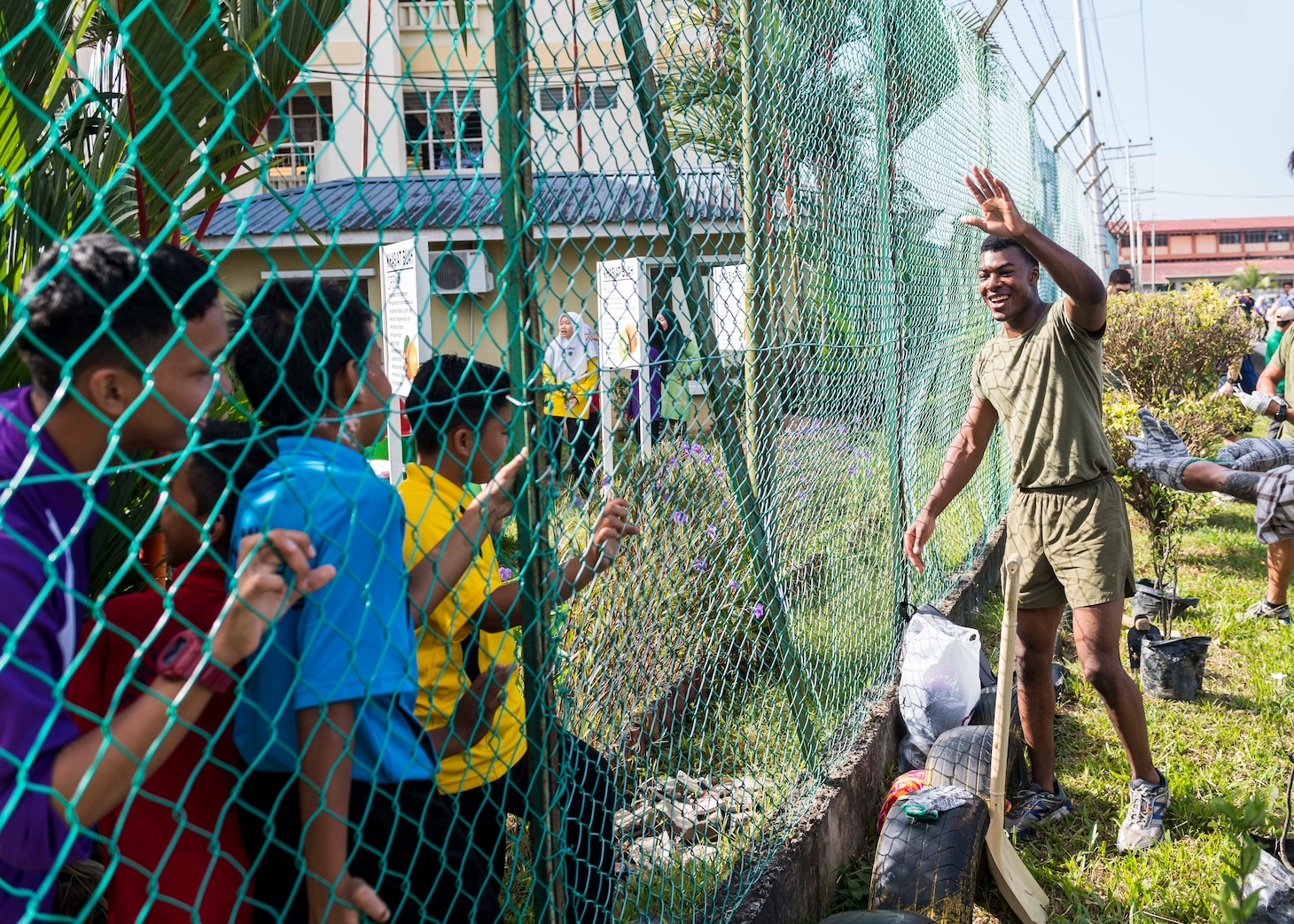 190225-N-WI365-1044 KOTA KINABALU, Malaysia (Feb. 25, 2019) – Lance Cpl. Daniel Notice, from Florissant, Miss., with the 31st Marine Expeditionary Unit (MEU) greets students from the Sekolah Menengah Kebangsaan Inanam High School during a cultural exchange and community service event.