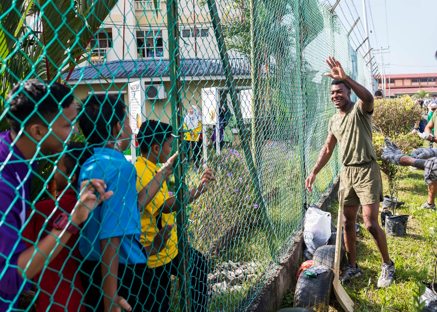 190225-N-WI365-1044 KOTA KINABALU, Malaysia (Feb. 25, 2019) – Lance Cpl. Daniel Notice, from Florissant, Miss., with the 31st Marine Expeditionary Unit (MEU) greets students from the Sekolah Menengah Kebangsaan Inanam High School during a cultural exchange and community service event.