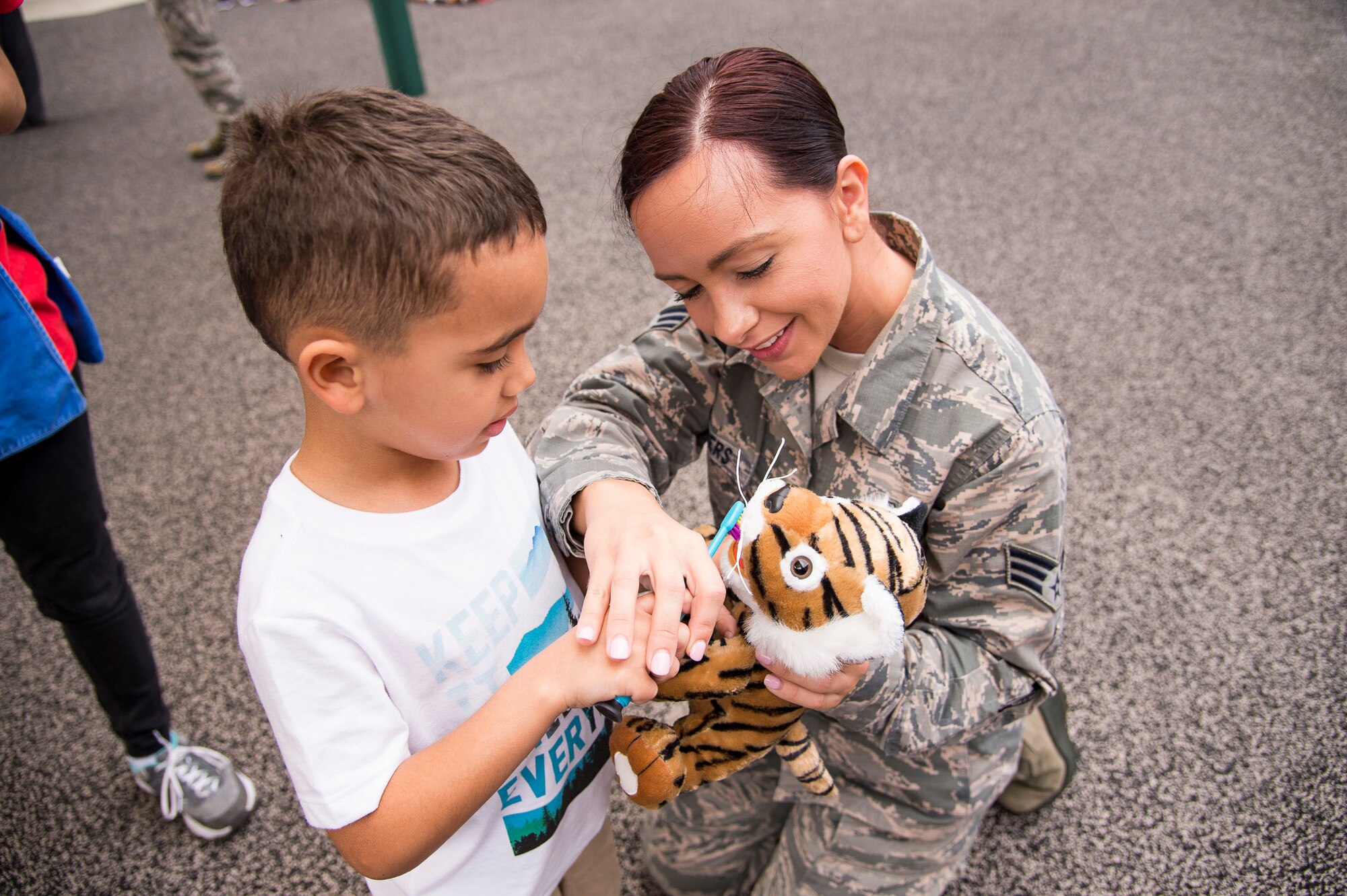 U.S. Air Force Senior Airman Shinique Manders, 23d Aeromedical Dental Squadron, helps a child use a toothbrush during a visit to the Child Development Center  at Moody Air Force Base, Georgia, Feb. 22, 2019. February is National Children’s Dental Health Month, a national health observance that brings together thousands of dedicated professionals, health care providers, and educators to promote the benefits of good oral health to children. (U.S. Air Force Photo by Andrea Jenkins)