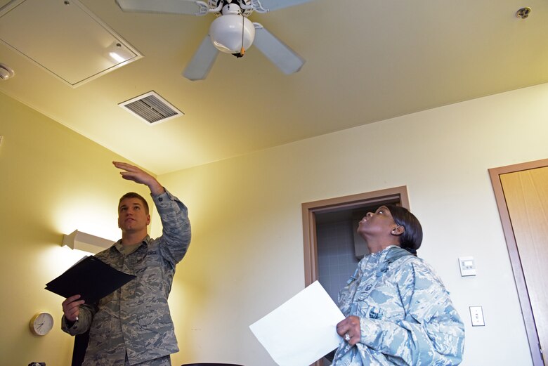 U.S. Air Force 1st Lt. Ryan Neimes, 8th Comptroller Squadron financial operations flight commander, and Master Sgt. Jawanica Woodard, 8th CPTS financial operations fight chief, inspect the ceiling in a dorm room at Kunsan Air Base, Republic of Korea, Feb. 26, 2019. Neimes and Woodward completed room inspections to ensure their Airmen had suitable living quarters. (U.S. Air Force photo by Staff Sgt. Joshua Edwards)