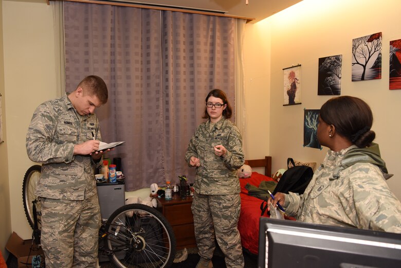 U.S. Air Force 1st Lt. Ryan Neimes, 8th Comptroller Squadron financial operations flight commander, takes notes while Senior Airman Allisha Quinn, 8th CPTS permanent change of station section specialist, talks about her dorm at Kunsan Air Base, Republic of Korea, Feb. 26, 2019. Neimes visited with all CPTS non-commissioned officers and junior airmen to check the quality of the rooms and to see if his personnel had any issues. (U.S. Air Force photo by Staff Sgt. Joshua Edwards)