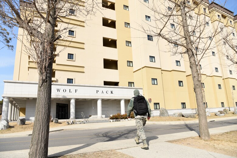 A U.S. Air Force Airman walks to his dorm at Kunsan Air Base, Republic of Korea, Feb. 26, 2019. The 8th Fighter Wing conducted a 100 percent review of the on-base housing to ensure proper health and wellness standards. (U.S. Air Force photo by Staff Sgt. Joshua Edwards)