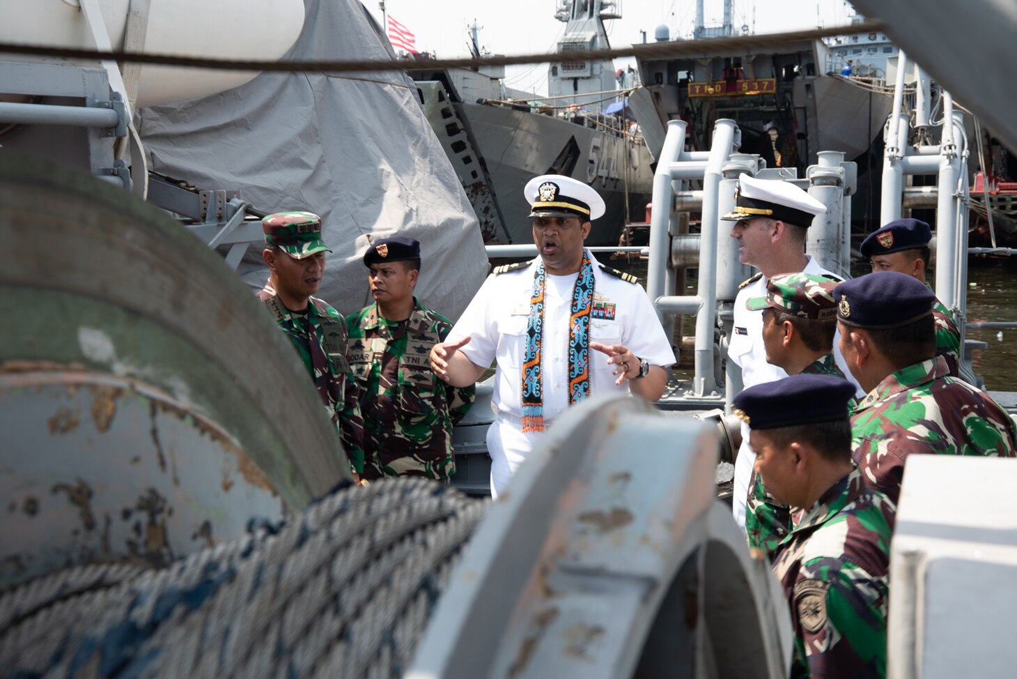JAKARTA, Indonesia (Feb. 26, 2019) Lt. Cmdr. Fred Crayton, commanding officer of the Avenger-class mine countermeasures ship USS Chief (MCM 14), briefs Indonesian Navy (TNI-AL) sailors about minesweeping equipment during a tour of the ship. Chief is visiting Jakarta while operating in U.S. 7th Fleet to work with their Indonesian Navy (TNI-AL) counterparts to strengthen regional security and stability, and enhance interoperability.